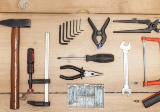 home improvement tools laid out on a wooden background